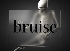 bruise word on glass and skeleton photo