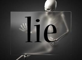 lie word on glass and skeleton photo