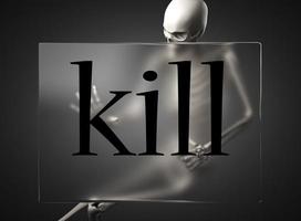 kill word on glass and skeleton photo