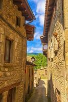 Beautiful view of scenic narrow alley with historic traditional houses and cobbled street in an old town in Europe with blue sky and clouds in summer with retro vintage