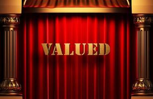 valued golden word on red curtain photo