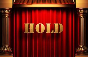hold golden word on red curtain photo