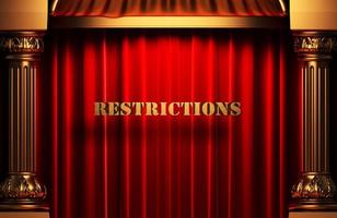 restrictions golden word on red curtain photo