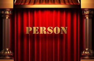 person golden word on red curtain photo