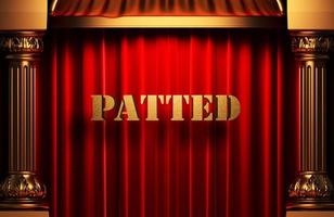 patted golden word on red curtain photo