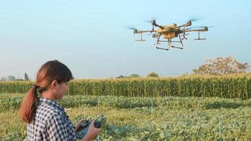 Smart farmer with drone spraying fertilizer and pesticide over farmland,High technology innovations and smart farming