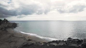 Waves crashing on the beach during a cloudy day video