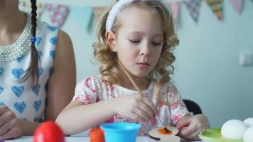 Cute Little Girl Painting Wooden Easter Bunny with Orange Color video