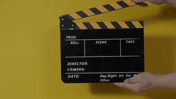 Movie slate or clapperboard hitting. Close up hand holding empty film slate and clapping it. video