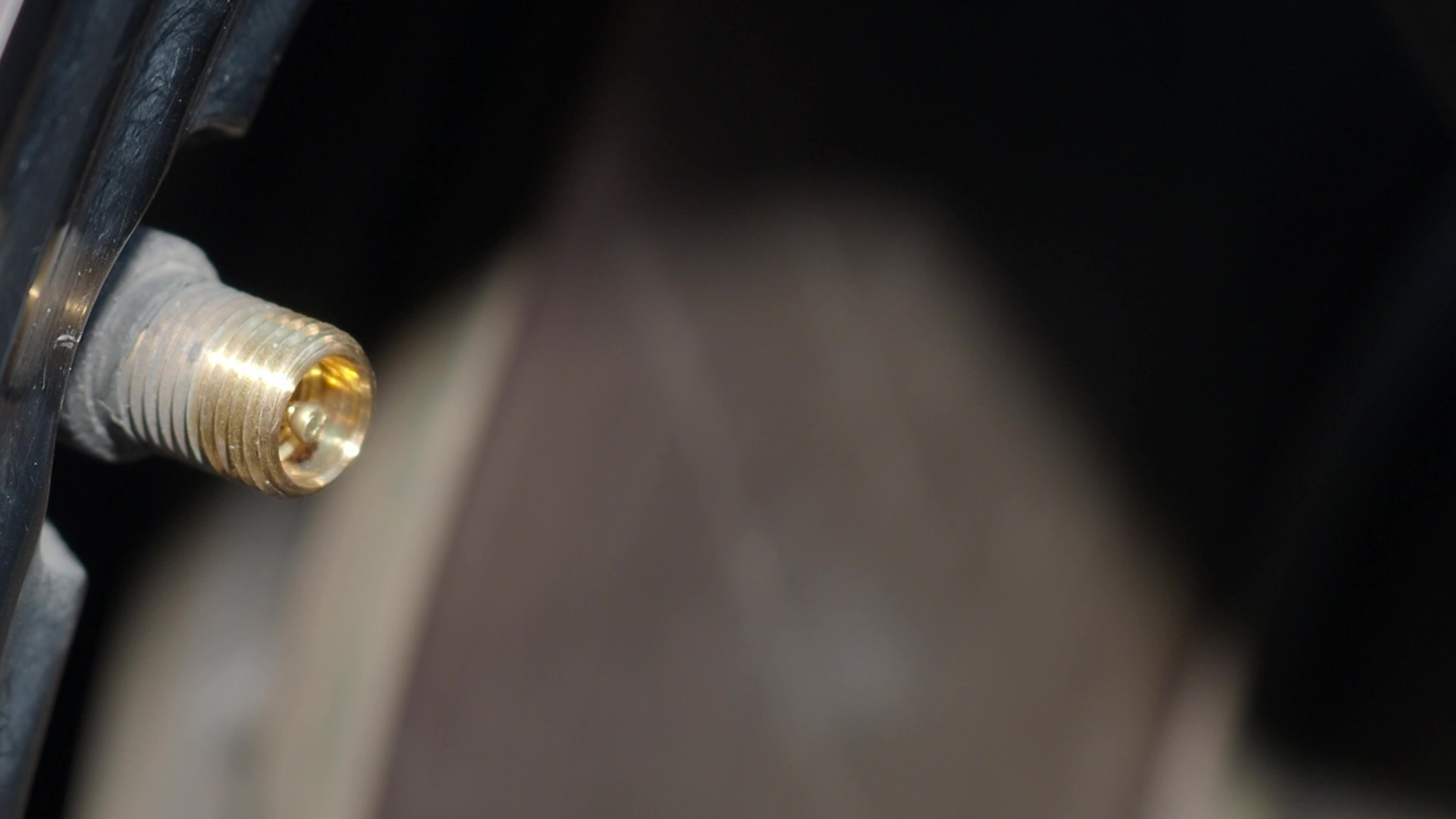 Inflating tire. man hand open valve cap and inflate car tyre before