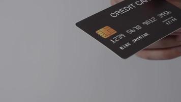 Man hand giving Credit card to woman hand. Isolated background. video