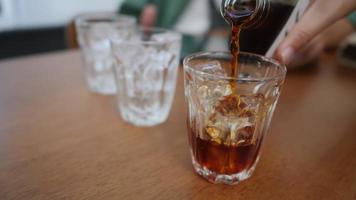 coffee cup, Pour coffee into a glass with ice, cold brew coffee, slow-motion in 4k video