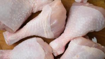 Raw, fresh chicken thigh, spinning in a circle on a chopping board. video