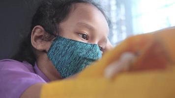 a upset child girl with face mask looking down video