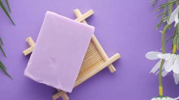 Homemade natural soap bar and lavender flower on purple background video