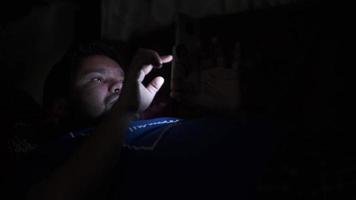 young man using smart phone at night video