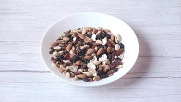 hand pick mixed nut from a plate video