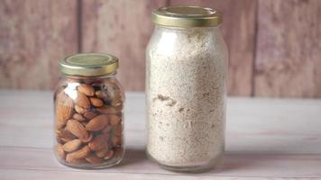 almond powder and almond in a jar on table,