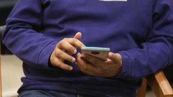 young man using smart phone indoor video