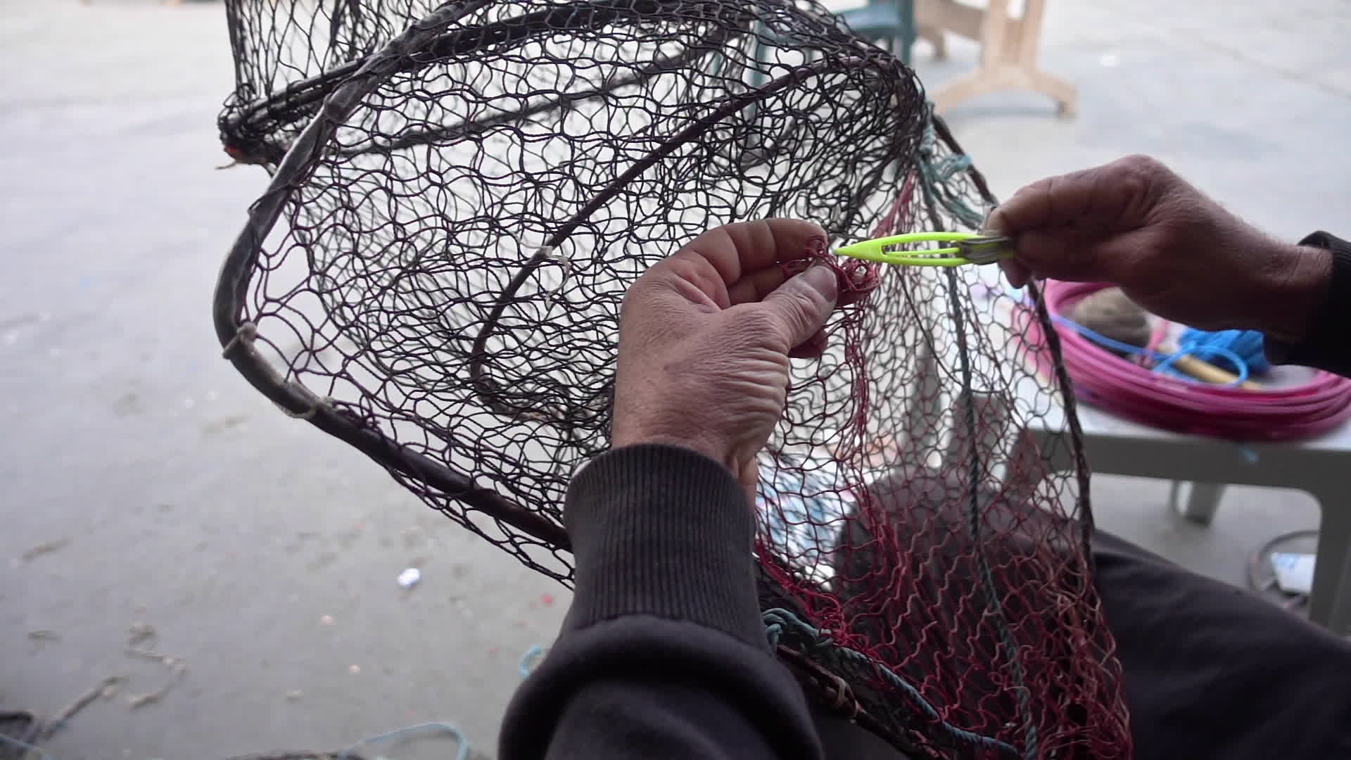 Fisherman Repairs Folding Fish Trap Net In The Marine 6300062 Stock Video  at Vecteezy