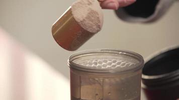 Serving A Portion Of Protein Powder Into The Shaker bottle video