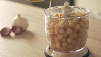 Process of how homemade hummus is made, with garlic, chickpeas, olive oil and spices video