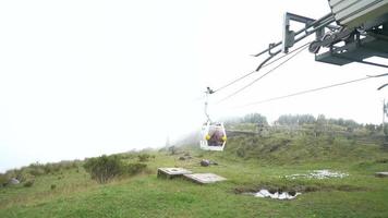 Quito, Ecuador, 2022 - Cabin with passengers arriving at the cable car station located in Cruz Loma on a very cloudy day