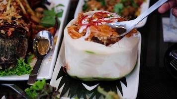 Use spoon scoop steamed seafood steamed with curry paste and coconut milk, Thai food