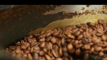 Aromatic Brown Coffee Beans Mixing in an Industrial Roasting Machine to make cooler and ready to Drink