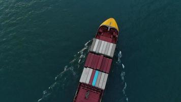 Aerial top view of smart cargo ship carrying container and running for export  goods  from  cargo yard port to other ocean concept freight shipping ship video