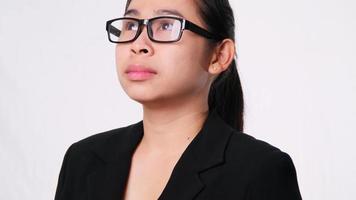 Confident Asian businesswoman looking up on white background in studio video