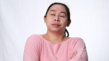 Asian woman thinking and looking up on white background in studio. video