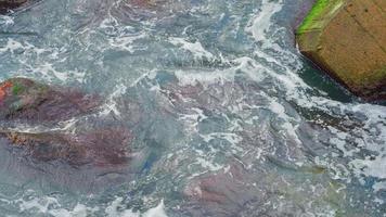 Waves breaking over rocks at seaside video