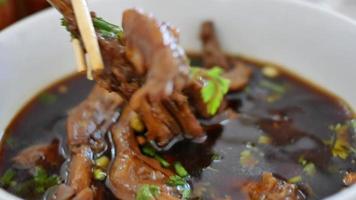 Chicken feet in hot and spicy soup in a bowl. Thai local food video