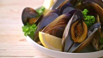 fresh mussels with herbs in a bowl with lemon video