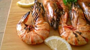 grilled tiger prawns or shrimps with lemon on wood board video