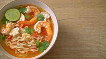 instant noodles ramen in spicy soup with shrimps or Tom Yum Kung - Asian food style video