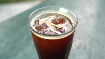 iced americano coffee glass on table in coffee shop cafe and restaurant video