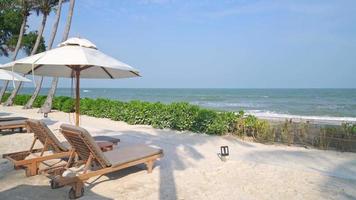Parasol avec chaise de plage et fond de mer océan - concept de vacances et de vacances video