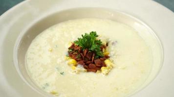 corn soup with crispy bacon on plate video