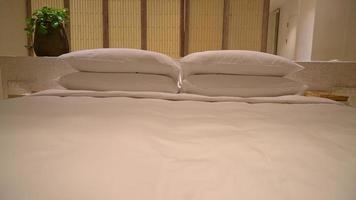 white pillows decoration on bed in luxury hotel resort bedroom