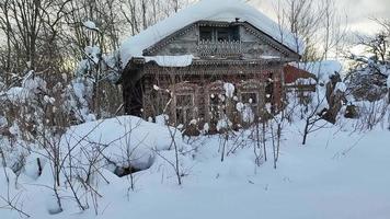 Old non-residential house in the village in winter.