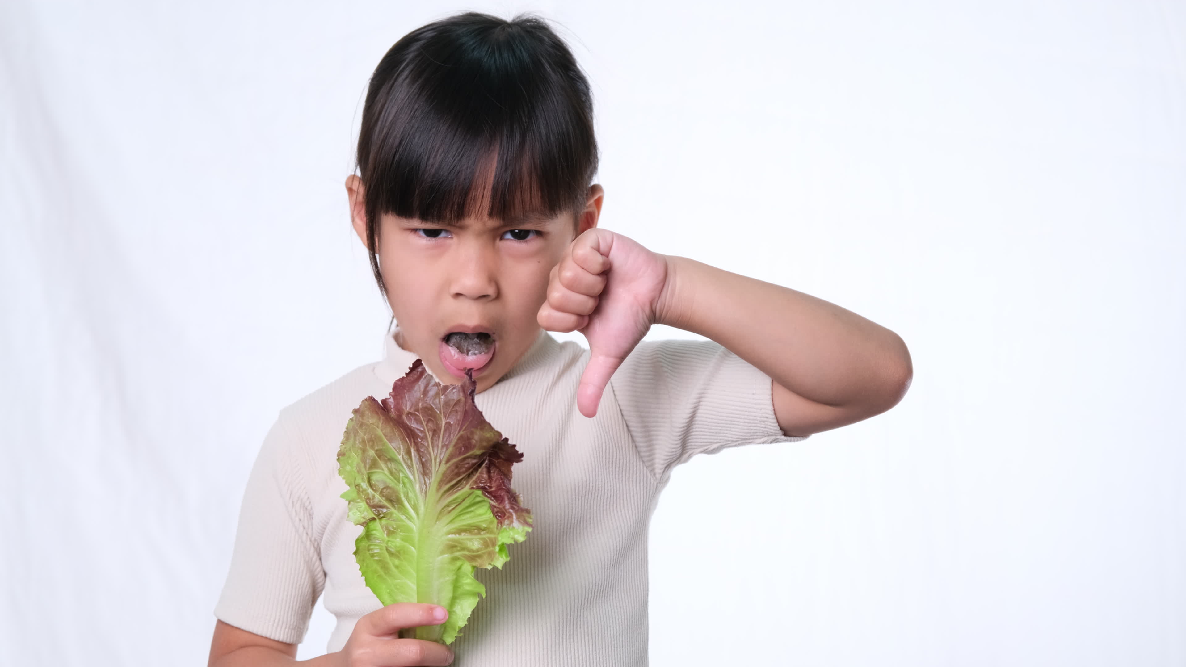 Children do not like to eat vegetables. Little girl who hates eating