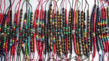 Quito, Ecuador, 2022 - Group of multicolored bracelets made by hand by indigenous Ecuadorians for sale in a craft market