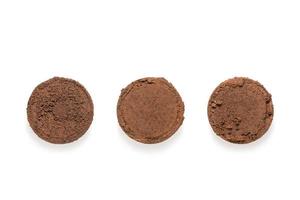 Ground coffee from coffee machine isolated on white background photo