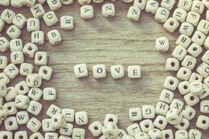 LOVE word of white english alphabet letters on wooden plank photo