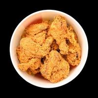 Set of fried chicken in round box for take away solated on black background photo