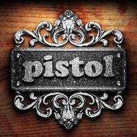 pistol word of iron on wooden background photo