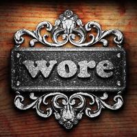 wore word of iron on wooden background photo