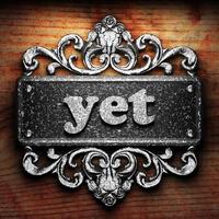 yet word of iron on wooden background photo
